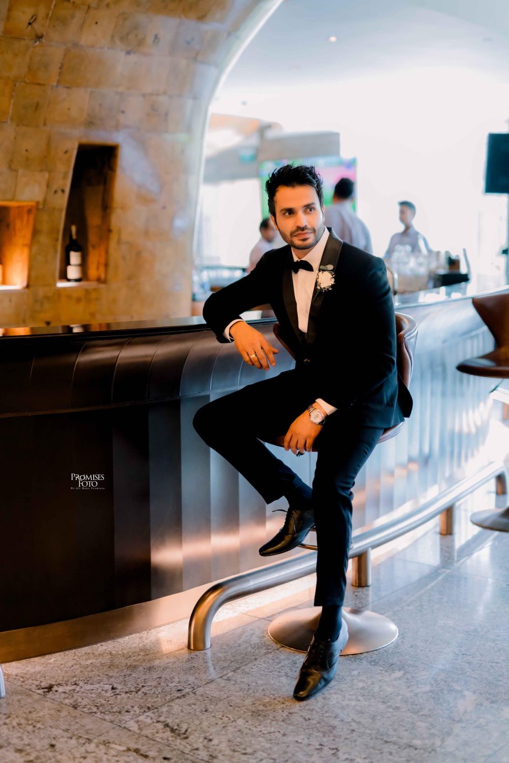 Groom in a black tuxedo with bow tie