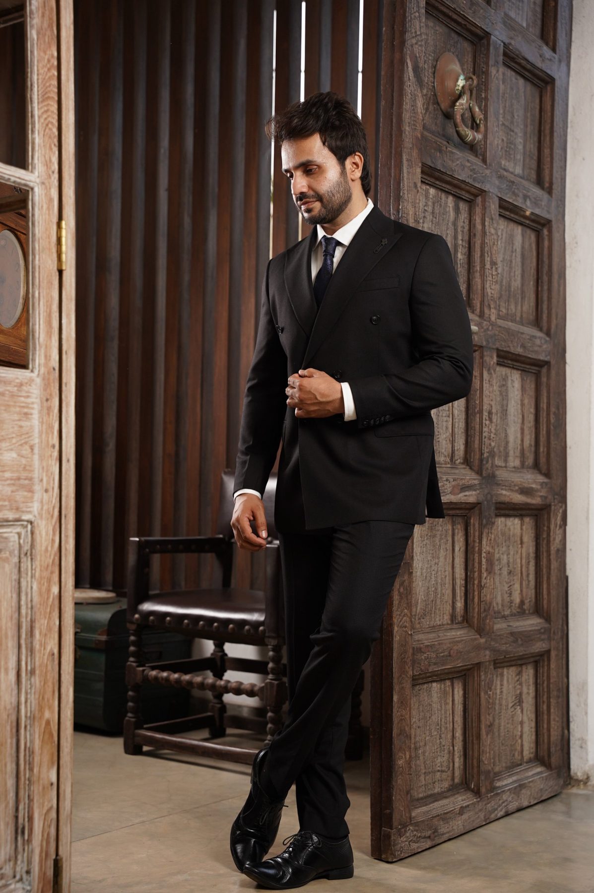 Groom in a black double-breasted suit
